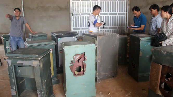 Lực lượng công an khám nghiệm những két sắt bị cạy phá - Ảnh: ĐỨC HUY